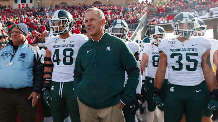 Michigan State head coach Mark Dantonio walks on the field with his players